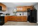 Well-lit kitchen with modern appliances, warm wood cabinets, and smooth countertop space at 7401 Cherry Blossom Way, Winston, GA 30187
