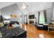 Spacious living room with a cozy fireplace, vaulted ceiling, and hardwood flooring at 7401 Cherry Blossom Way, Winston, GA 30187
