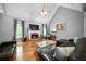 Inviting living area featuring a brick fireplace, large windows, and hardwood floors at 7401 Cherry Blossom Way, Winston, GA 30187