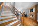 Inviting living room featuring hardwood floors, a staircase, and a brick fireplace with a TV at 7401 Cherry Blossom Way, Winston, GA 30187