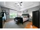 Serene main bedroom featuring a tray ceiling and ample natural light at 7401 Cherry Blossom Way, Winston, GA 30187