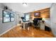 Bright home office featuring hardwood floors, wood-paneled accent wall and modern computer equipment at 7401 Cherry Blossom Way, Winston, GA 30187