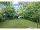 Large backyard is mostly grass and has mature trees surrounding it for privacy at 1591 Jonesboro Se Rd, Atlanta, GA 30315