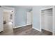 Cozy room featuring wood flooring, blue walls, and multiple doors for easy access to other areas at 1591 Jonesboro Se Rd, Atlanta, GA 30315