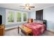 Comfortable bedroom features three windows, ceiling fan, wood floors, and a bed with a patterned comforter at 1591 Jonesboro Se Rd, Atlanta, GA 30315