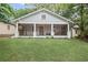 Inviting home with a classic screened-in porch and well-maintained lawn at 1591 Jonesboro Se Rd, Atlanta, GA 30315