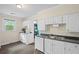 Classic kitchen featuring white cabinets, modern appliances, wood floors, and natural light at 1591 Jonesboro Se Rd, Atlanta, GA 30315