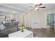 Cozy living room featuring a decorative fireplace, ceiling fan and hardwood flooring at 1591 Jonesboro Se Rd, Atlanta, GA 30315