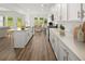 Modern open kitchen with stainless appliances, white cabinets, and a center island, connected to the dining area at 206 Sharon Ln, Loganville, GA 30052