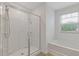 Bathroom featuring a glass-enclosed shower and a soaking tub, providing a spa-like experience at home at 3825 Sycamore Hill Dr, Loganville, GA 30052