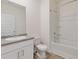 Clean bathroom with a shower/tub combo, white vanity, and tile flooring at 3825 Sycamore Hill Dr, Loganville, GA 30052