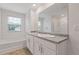 Bright bathroom featuring double sinks, a bathtub, and a shower, offering complete relaxation and functionality at 3825 Sycamore Hill Dr, Loganville, GA 30052