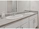 Bathroom featuring double sink vanity with modern fixtures and a large mirror at 3825 Sycamore Hill Dr, Loganville, GA 30052