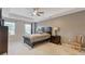 A bedroom with neutral walls, carpeted floors, ceiling fan, and a dark wood bedroom set at 3825 Sycamore Hill Dr, Loganville, GA 30052