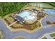 Aerial view showcasing a luxurious community pool area with ample seating, landscaping, and shade structures at 3825 Sycamore Hill Dr, Loganville, GA 30052