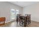Dining room with wood flooring, table with six chairs, and double doors leading to the yard at 3825 Sycamore Hill Dr, Loganville, GA 30052