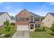 Beautiful two-story brick home featuring a two-car garage, a well-maintained lawn, and mature trees at 3825 Sycamore Hill Dr, Loganville, GA 30052
