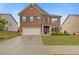 Charming two-story brick home featuring a two-car garage, manicured lawn, and a welcoming entrance at 3825 Sycamore Hill Dr, Loganville, GA 30052