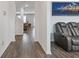 Hallway with wood flooring leading to living areas, with a gray leather sofa at 3825 Sycamore Hill Dr, Loganville, GA 30052