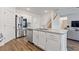 Open kitchen featuring a large island, stainless steel appliances, granite countertops, and hardwood floors at 3825 Sycamore Hill Dr, Loganville, GA 30052