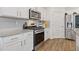 Well-equipped kitchen with stainless steel appliances, granite countertops, and white cabinets at 3825 Sycamore Hill Dr, Loganville, GA 30052