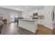 Open kitchen with white cabinets, granite counters, stainless appliances and center island at 3825 Sycamore Hill Dr, Loganville, GA 30052