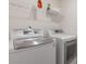 Laundry room equipped with modern washer and dryer, making laundry chores a breeze at 3825 Sycamore Hill Dr, Loganville, GA 30052