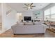 Comfortable living room with hardwood floors, a ceiling fan, and access to the staircase at 3825 Sycamore Hill Dr, Loganville, GA 30052