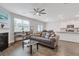 Spacious living room featuring a fireplace, hardwood floors, and access to the kitchen at 3825 Sycamore Hill Dr, Loganville, GA 30052