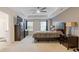 Large main bedroom with a ceiling fan, dresser, and ensuite bathroom at 3825 Sycamore Hill Dr, Loganville, GA 30052