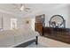 Bright main bedroom with a ceiling fan, TV, dresser, and an attached bathroom for convenience at 3825 Sycamore Hill Dr, Loganville, GA 30052