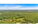 An aerial view reveals the property's verdant surroundings, nestled in a lush, green landscape at 7783 Cantrell Rd, Douglasville, GA 30135