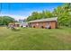 Expansive backyard featuring a mix of grassy lawn and shady trees at 7783 Cantrell Rd, Douglasville, GA 30135