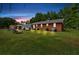 Spacious backyard with lush lawn, trees, and outdoor furniture for relaxing at 7783 Cantrell Rd, Douglasville, GA 30135