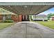 Covered carport and driveway, leading to a brick home at 7783 Cantrell Rd, Douglasville, GA 30135