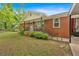 Charming brick home with landscaped front yard, covered porch, and private car port at 7783 Cantrell Rd, Douglasville, GA 30135