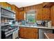 Charming kitchen featuring wooden cabinets, stainless steel appliances, and a window view at 7783 Cantrell Rd, Douglasville, GA 30135