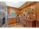 Quaint kitchen with wood paneling, stainless steel appliances and rustic decor at 7783 Cantrell Rd, Douglasville, GA 30135