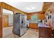 Cozy kitchen with wood cabinets, stainless steel appliances, and adjacent dining area at 7783 Cantrell Rd, Douglasville, GA 30135
