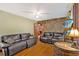 Cozy living room with hardwood floors, stone accent wall, and comfortable seating at 7783 Cantrell Rd, Douglasville, GA 30135