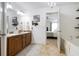 Bright bathroom featuring double vanity with wood cabinets and a view into the main bedroom at 13 Cottage Nw Walk, Cartersville, GA 30121