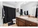 Neutral bathroom with a dark shower curtain and single vanity at 13 Cottage Nw Walk, Cartersville, GA 30121