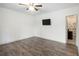 Empty bedroom with hardwood floors and a television mounted on the wall at 13 Cottage Nw Walk, Cartersville, GA 30121