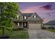 Charming two-story home with a stone facade, two-car garage, and well-manicured lawn at twilight at 13 Cottage Nw Walk, Cartersville, GA 30121