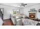 Cozy living room with stone fireplace, ceiling fan and plush sectional sofa for relaxing and entertaining at 13 Cottage Nw Walk, Cartersville, GA 30121