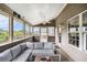 Relaxing screened porch with comfortable seating, ceiling fans, and a view of the serene backyard at 13 Cottage Nw Walk, Cartersville, GA 30121