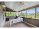 Relaxing screened porch with comfortable seating, ceiling fans, and a view of the serene backyard at 13 Cottage Nw Walk, Cartersville, GA 30121