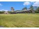 An open field with two silos, a covered area, and a small house in the background at 165 Craines Vw, Covington, GA 30014