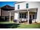Well-maintained backyard with a covered patio seating area and a large lawn at 165 Craines Vw, Covington, GA 30014