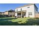 Spacious backyard features a covered patio, lush lawn, and privacy fence at 165 Craines Vw, Covington, GA 30014